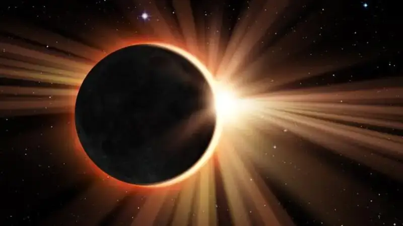 Total solar eclipse with the Moon blocking the Sun and bright solar rays radiating into space.
